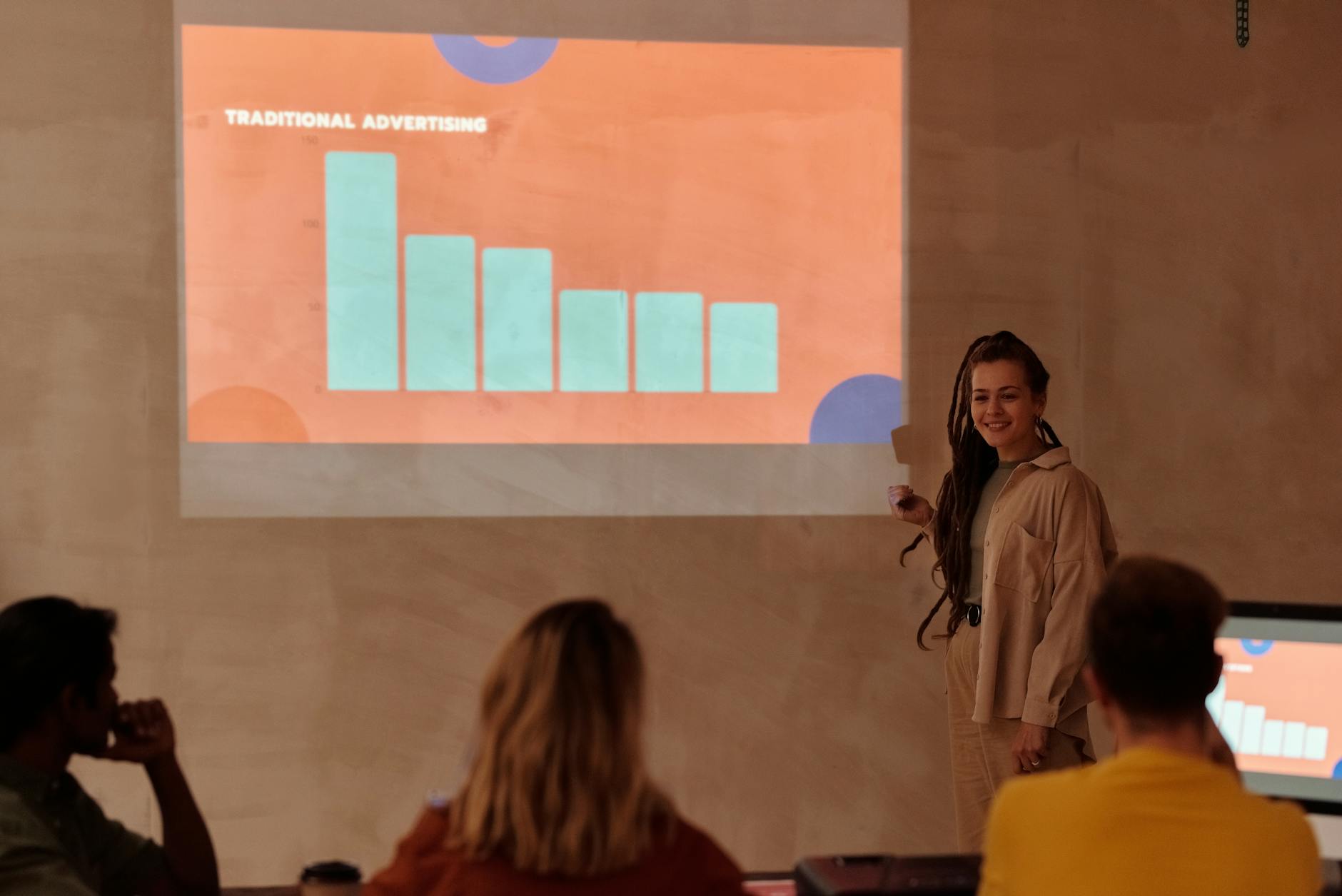 A small business owner reviewing Google Ads campaign performance on a laptop, with charts and data visualizations, symbolizing a Google Ads guide for beginners.