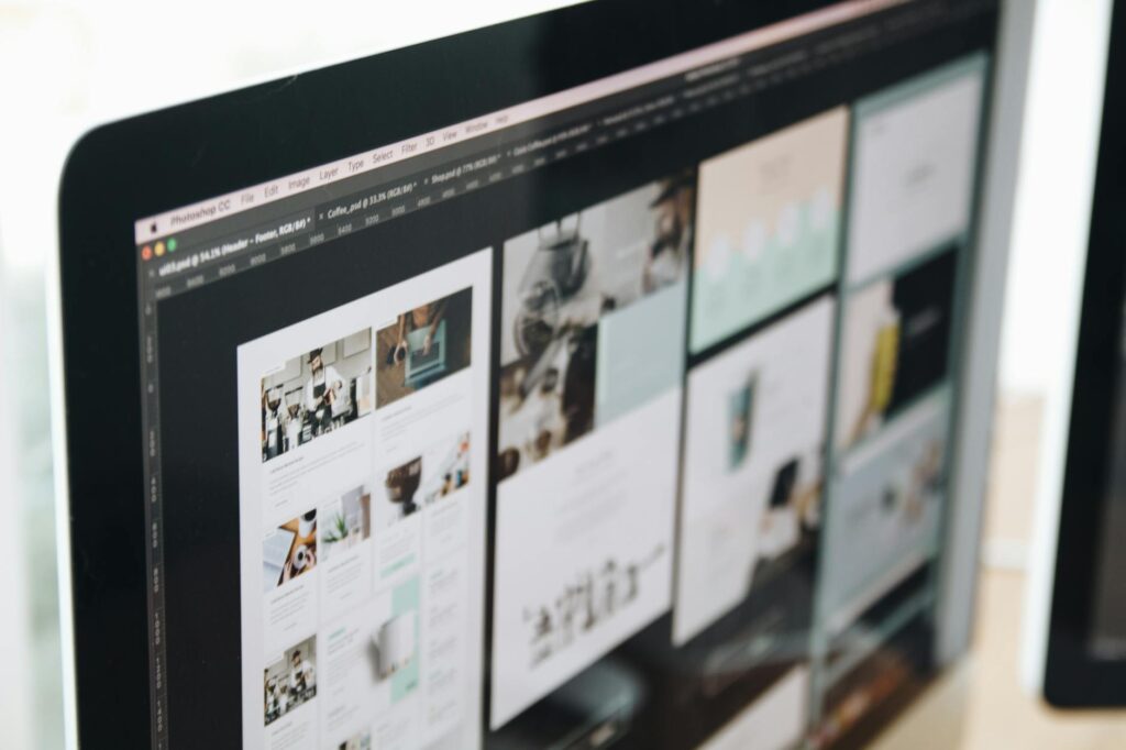 A sleek, modern business website interface displayed on a laptop, showcasing various web design trends like clean layouts, engaging visuals, and mobile responsiveness.