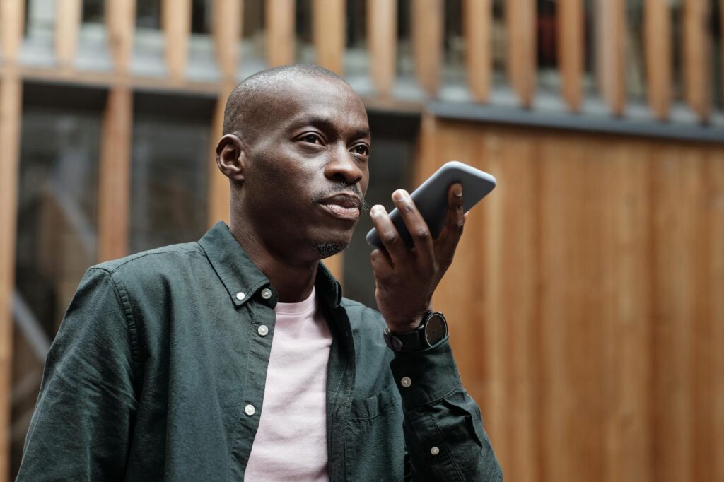 A person using a smartphone to interact with a voice assistant, demonstrating the rise of voice search technology and its impact on SEO.