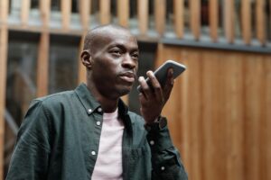 A person using a smartphone to interact with a voice assistant, demonstrating the rise of voice search technology and its impact on SEO.