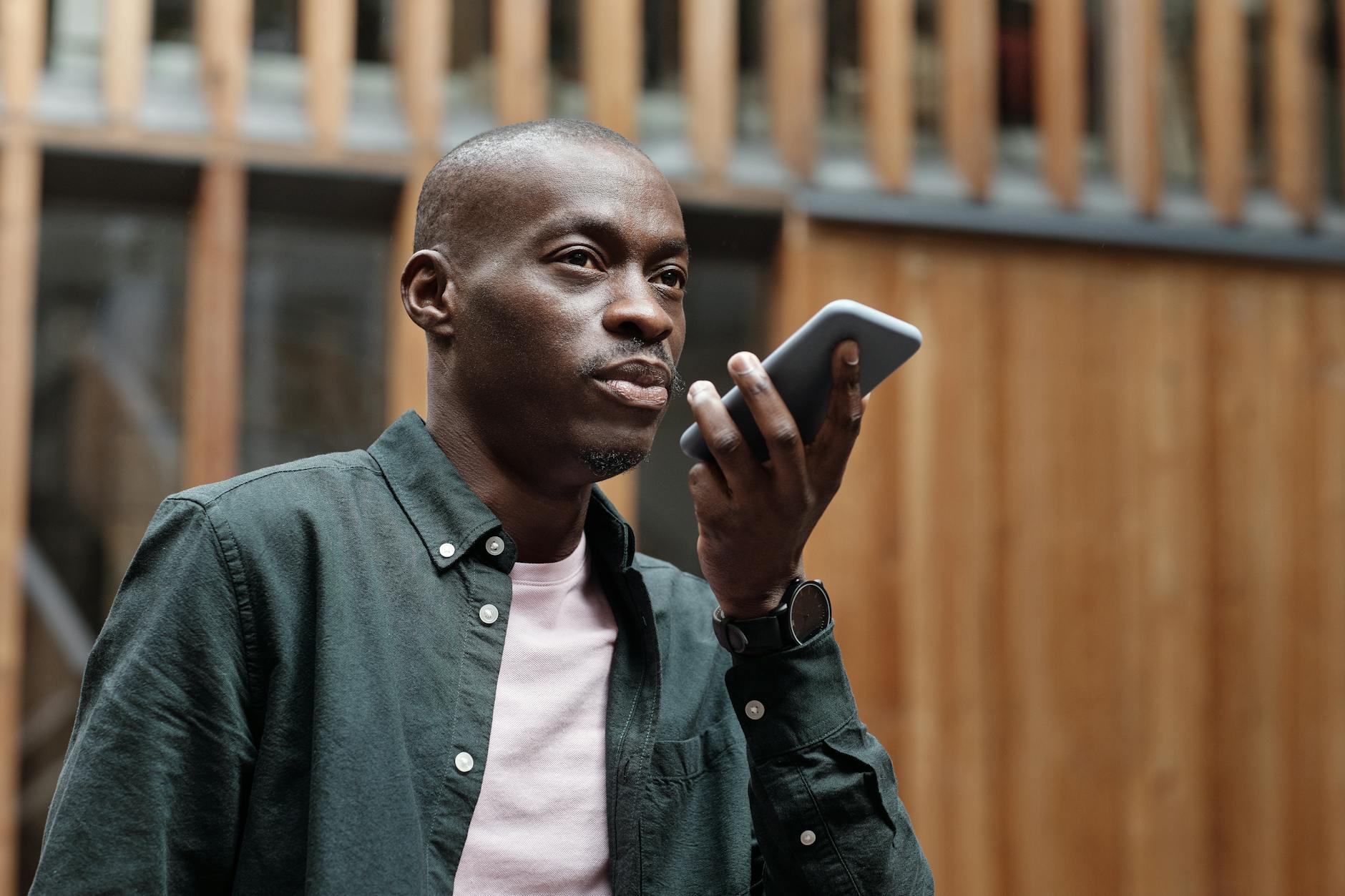 A person using a smartphone to interact with a voice assistant, demonstrating the rise of voice search technology and its impact on SEO.